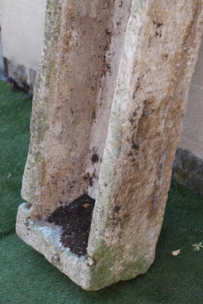 A LARGE GRANITE TROUGH of rough hewn narrow oblong form with mildly tapering sides Image