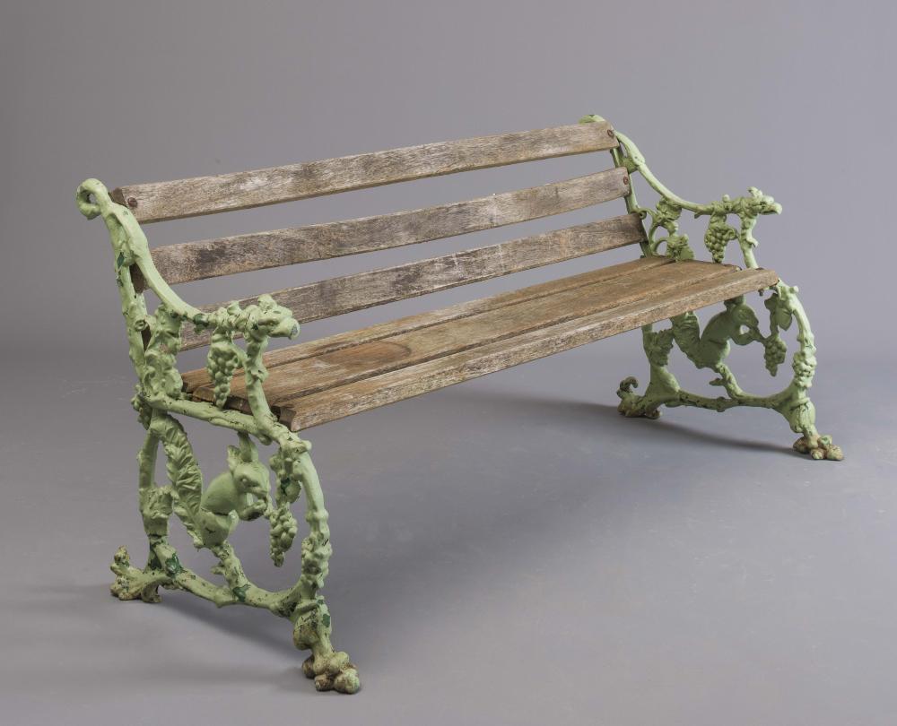 A VICTORIAN CAST IRON SEAT in squirrel and grape pattern with slatted hard wood seat and back Image