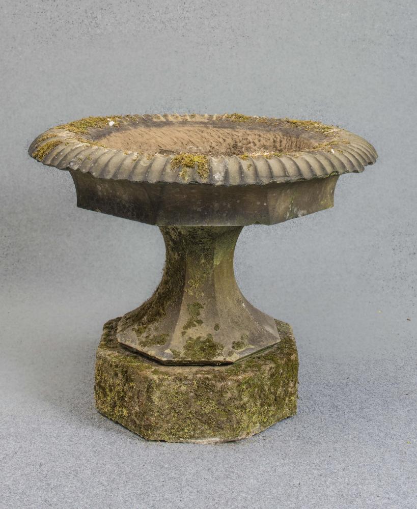 A LARGE VICTORIAN SANDSTONE URN of circular faceted form Image