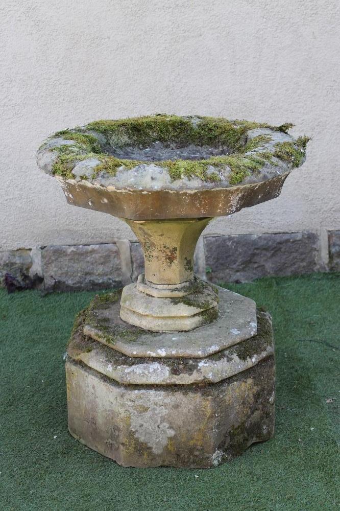A VICTORIAN SANDSTONE URN of circular faceted form Image