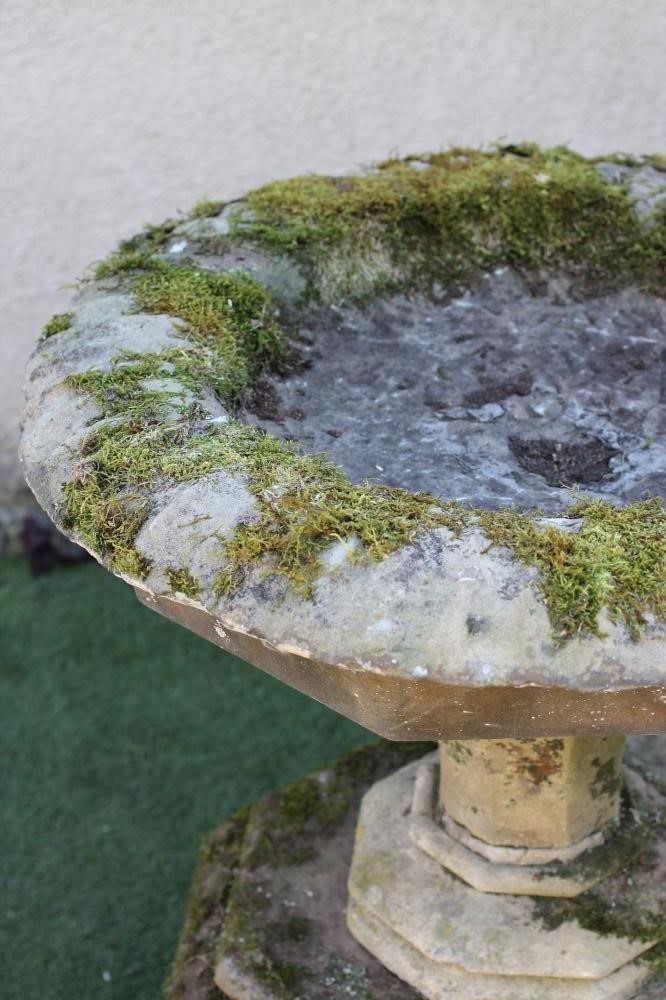 A VICTORIAN SANDSTONE URN of circular faceted form Image