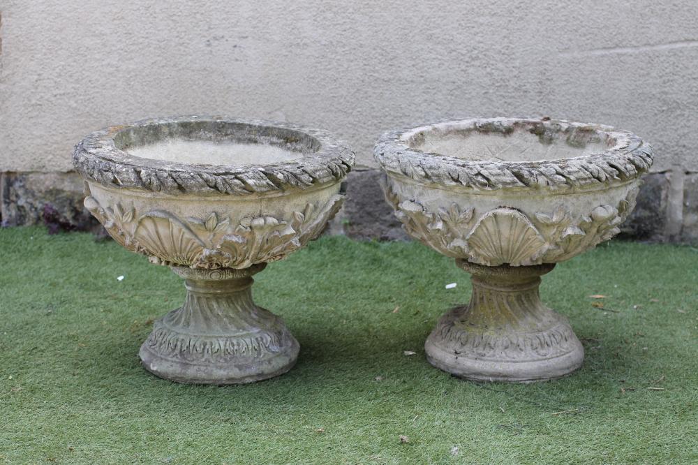A PAIR OF COMPOSITION STONE URNS Image