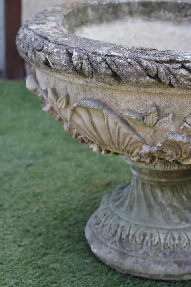 A PAIR OF COMPOSITION STONE URNS Image