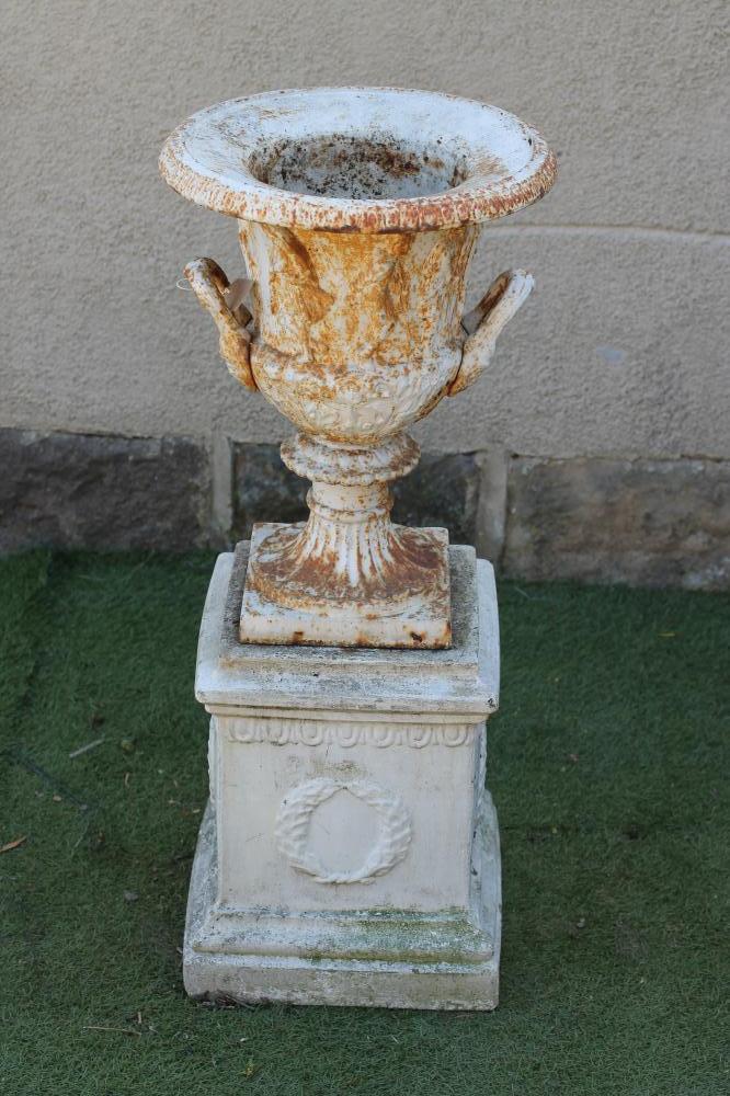A VICTORIAN CAST IRON URN of campana form with mask loop handles Image