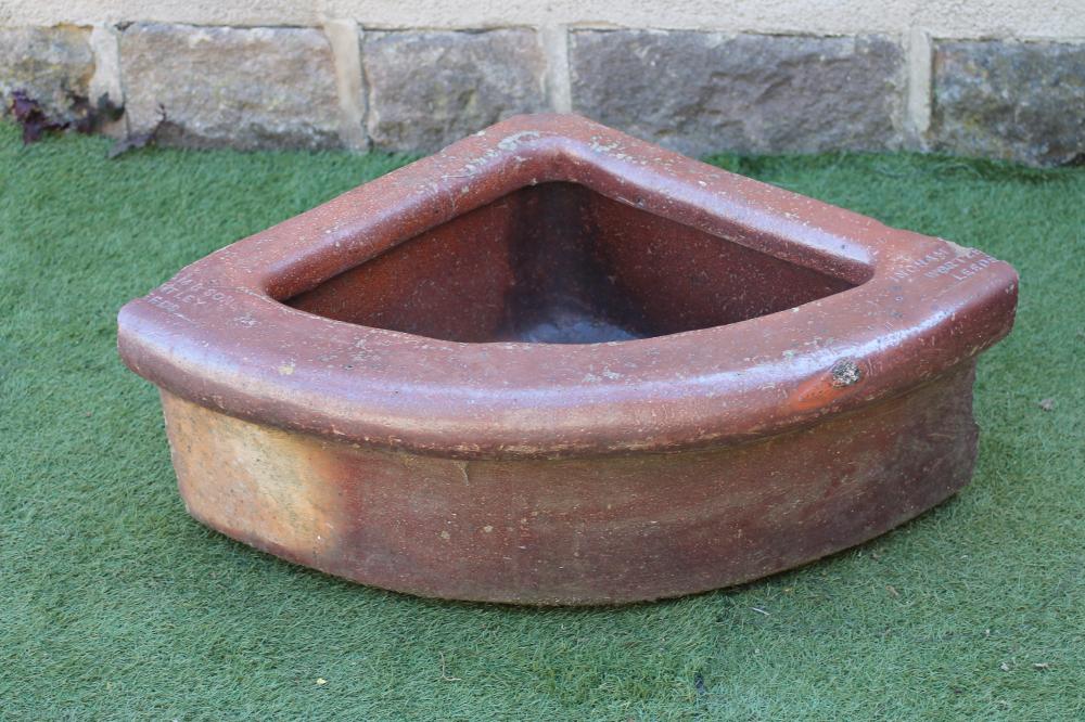 A SALTGLAZE STONEWARE TROUGH of quadrant form with moulded rim Image