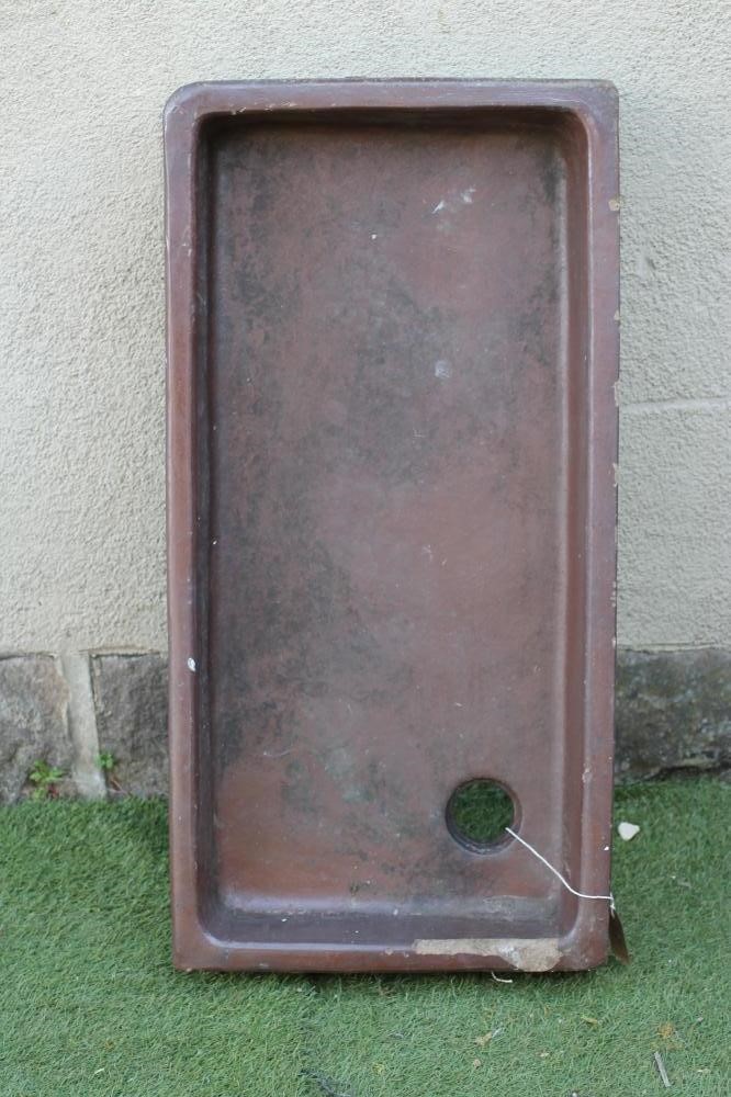 A SALTGLAZE STONEWARE TROUGH of quadrant form with moulded rim Image