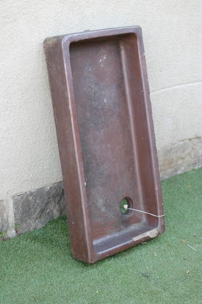 A SALTGLAZE STONEWARE TROUGH of quadrant form with moulded rim Image
