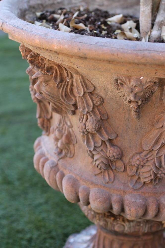 A TERRACOTTA URN of half fluted campana form Image