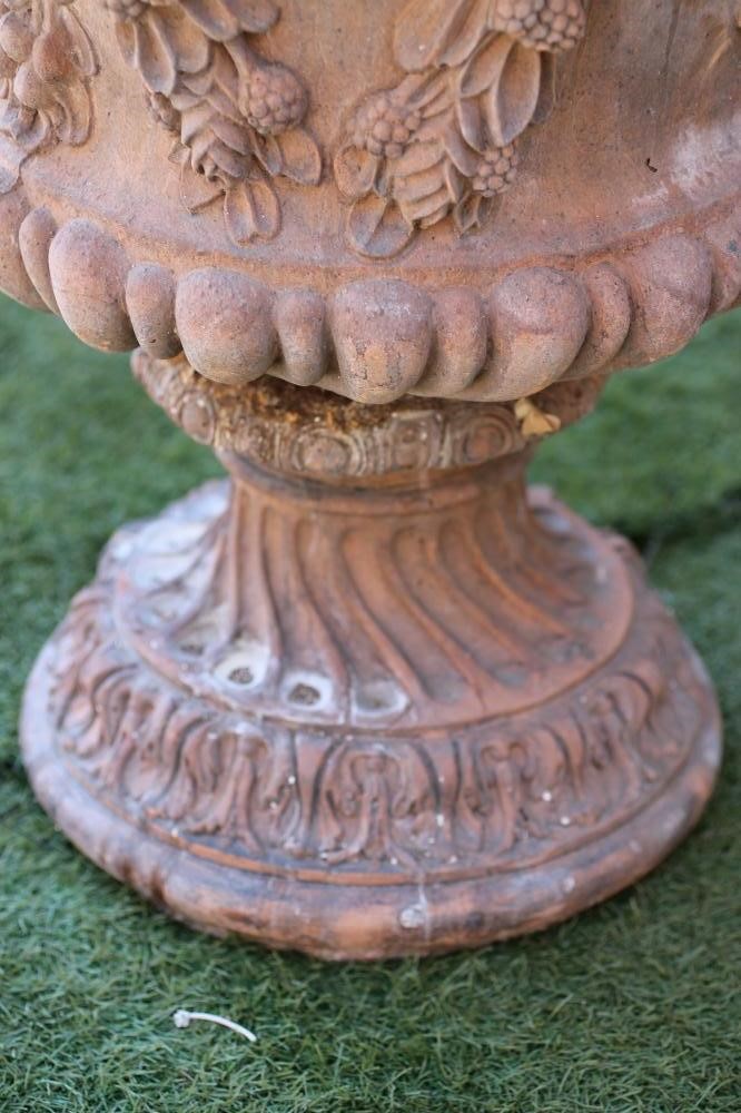 A TERRACOTTA URN of half fluted campana form Image