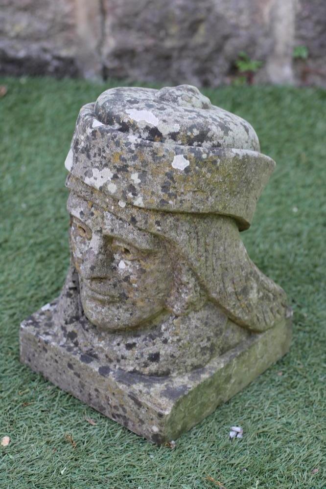 A CARVED SANDSTONE BUST of a Renaissance man wearing a hat Image