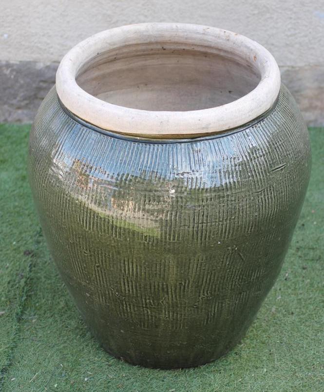 A LARGE GREEN GLAZED CERAMIC POT Image