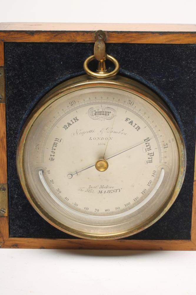 A BRASS CASED ANEROID BAROMETER by Negretti & Zambra Image