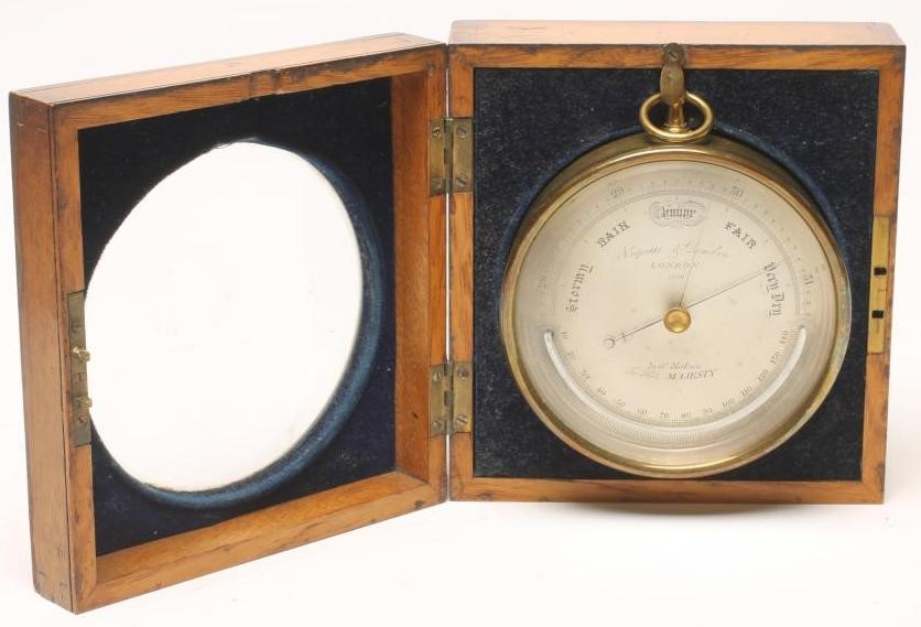 A BRASS CASED ANEROID BAROMETER by Negretti & Zambra Image