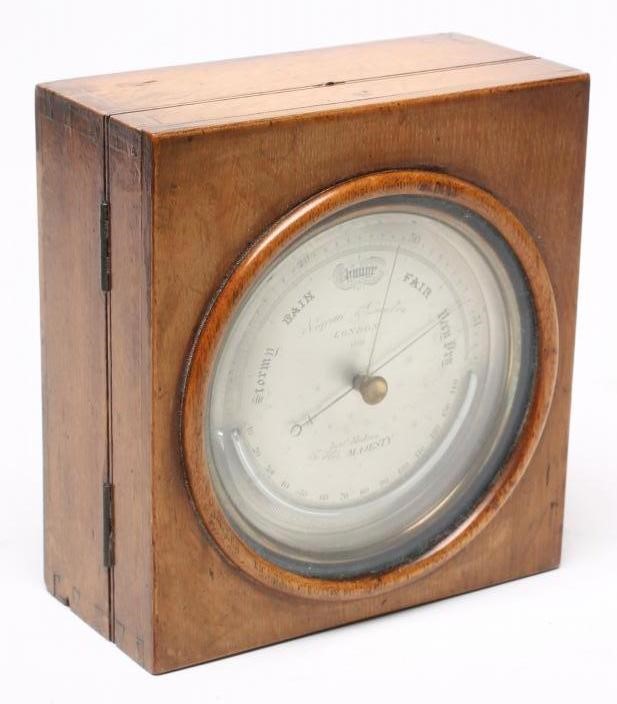 A BRASS CASED ANEROID BAROMETER by Negretti & Zambra Image