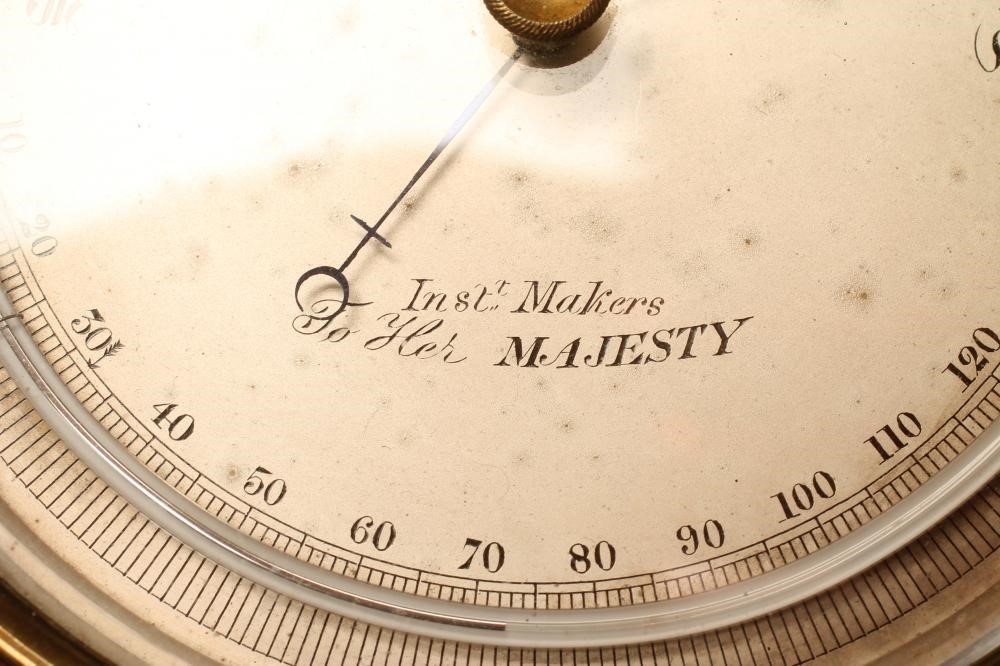 A BRASS CASED ANEROID BAROMETER by Negretti & Zambra Image