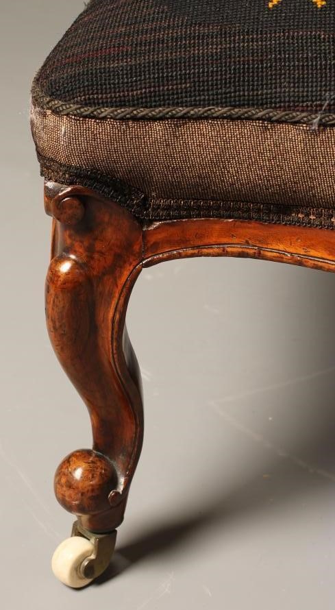 A VICTORIAN WALNUT FRAMED NURSING CHAIR of spoon back form upholstered in gros point with flowers on Image