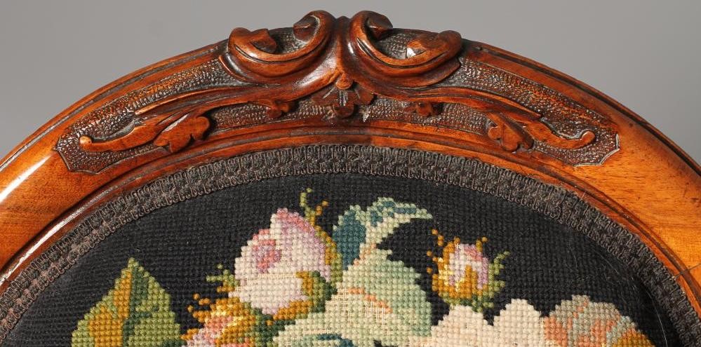 A VICTORIAN WALNUT FRAMED NURSING CHAIR of spoon back form upholstered in gros point with flowers on Image