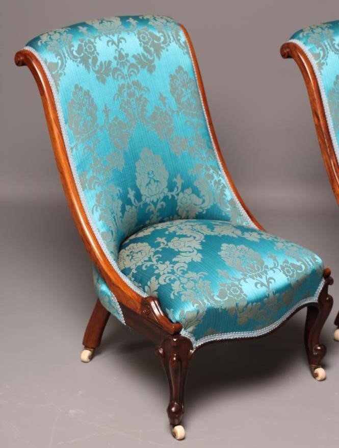 A PAIR OF VICTORIAN ROSEWOOD SALON CHAIRS of Grecian form upholstered in turquoise silk brocade Image