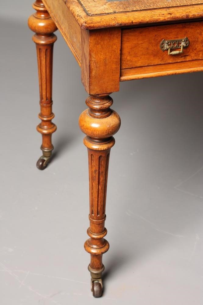 A VICTORIAN POLLARD OAK WRITING TABLE Image