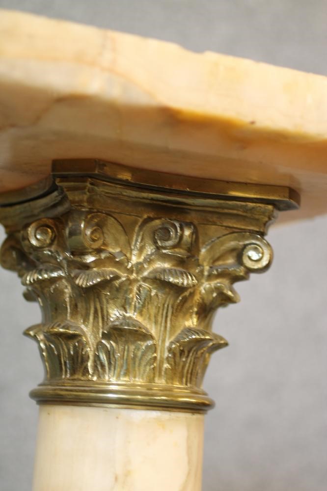 A VEINED WHITE ONYX AND GILT METAL PEDESTAL Image