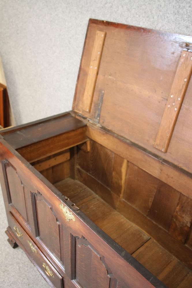 AN OAK PANELLED CHEST Image
