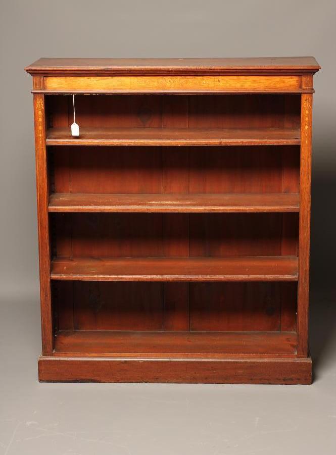 A LATE VICTORIAN MAHOGANY OPEN BOOKCASE of shallow oblong form with stringing and with marquetry Image