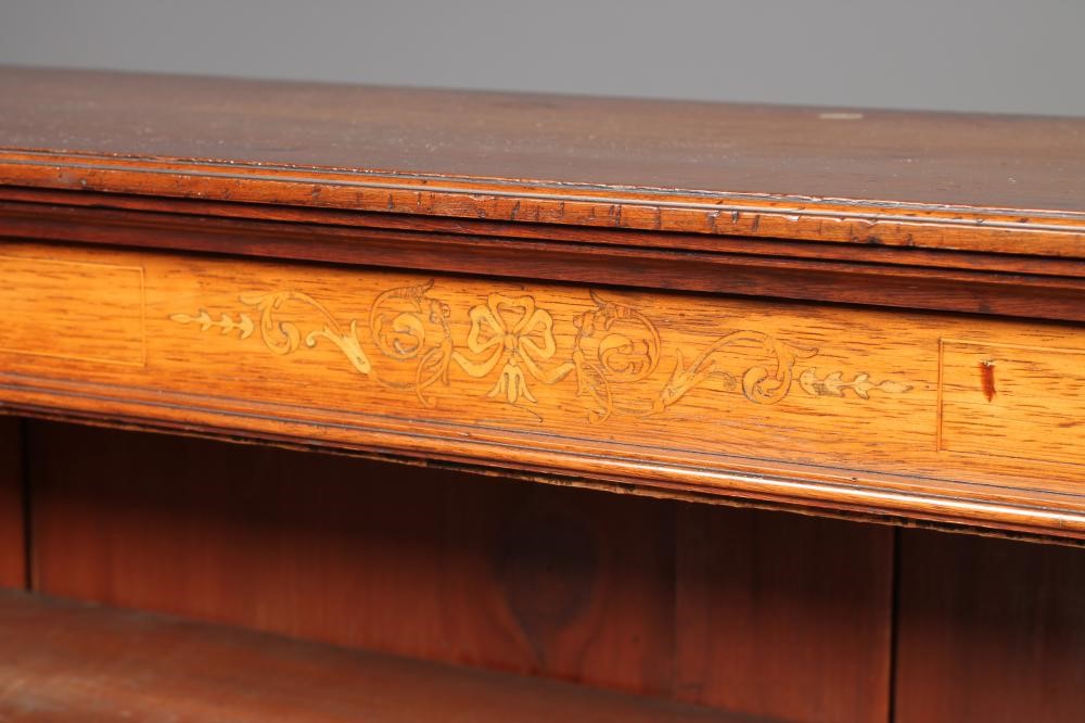 A LATE VICTORIAN MAHOGANY OPEN BOOKCASE of shallow oblong form with stringing and with marquetry Image