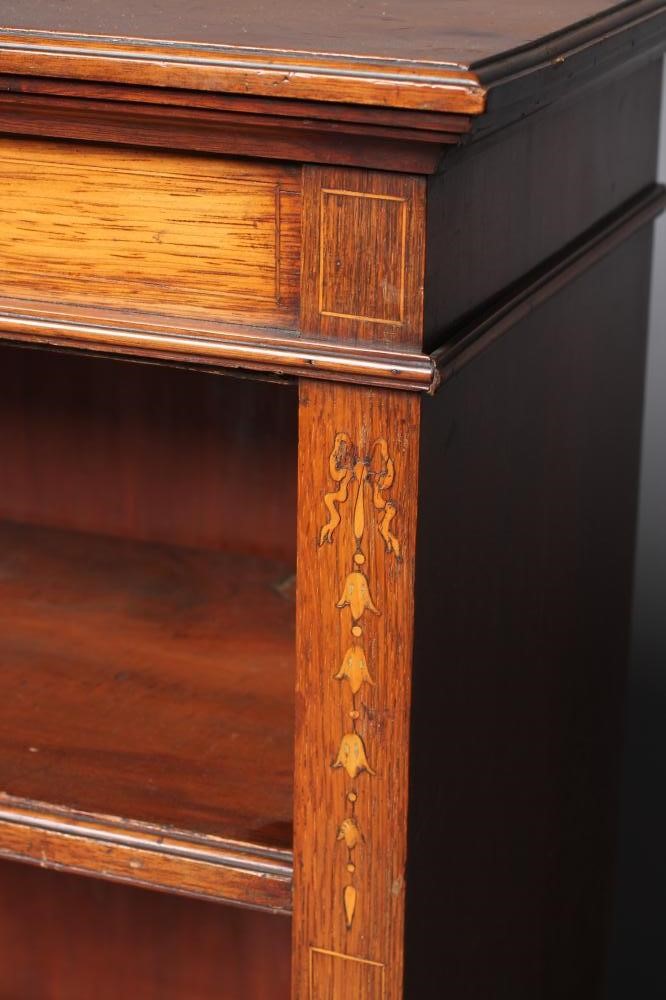 A LATE VICTORIAN MAHOGANY OPEN BOOKCASE of shallow oblong form with stringing and with marquetry Image