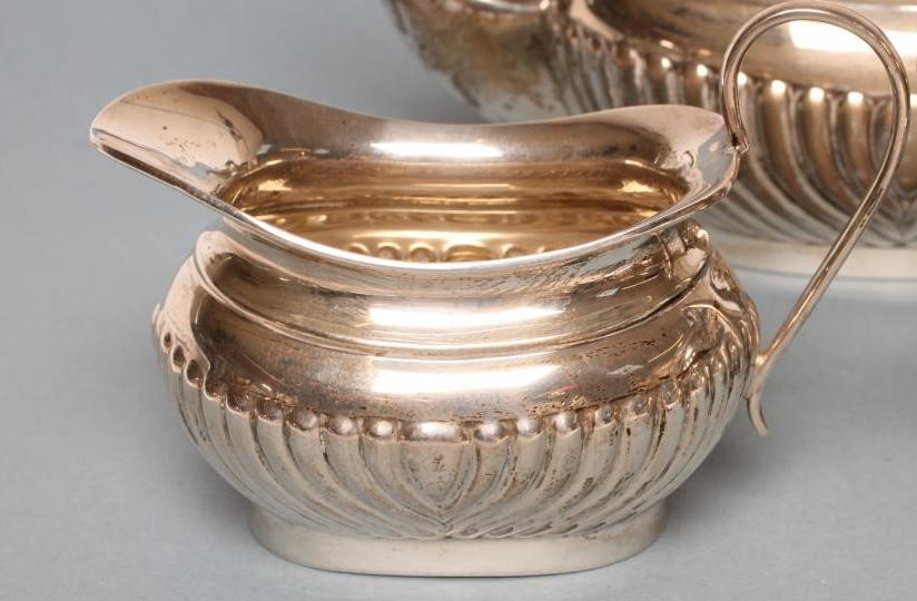 A COMPOSITE THREE PIECE SILVER TEA SERVICE Image