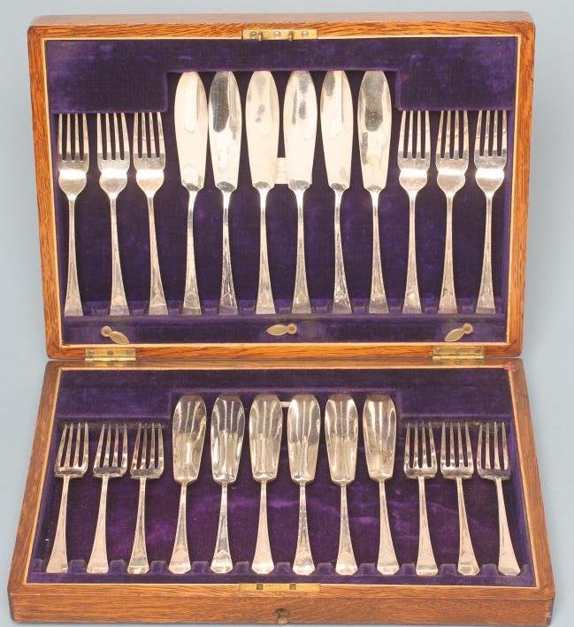 *A SET OF TWELVE PAIRS OF SILVER FISH KNIVES AND FORKS Image