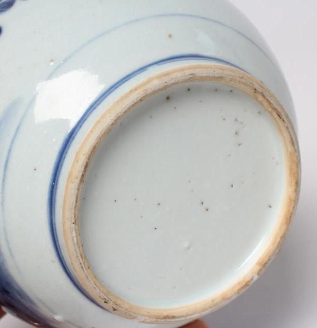 A CHINESE PORCELAIN GUGLET of typical bottle form, painted in underglaze blue with a pagoda in Image