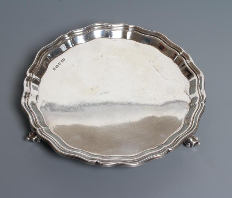 A SMALL SILVER SALVER, by Viners, Sheffield 1936, of shaped circular form with pie-crust rim, raised Image