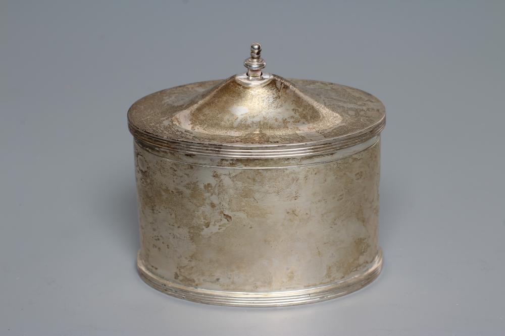 A SILVER TEA CANISTER, by Stokes & Ireland, Chester 1929, of oval section with cast and applied Image