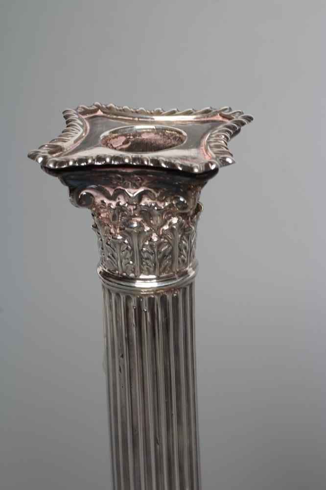 A PAIR OF LATE VICTORIAN SILVER CORINTHIAN COLUMN CANDLESTICKS Image