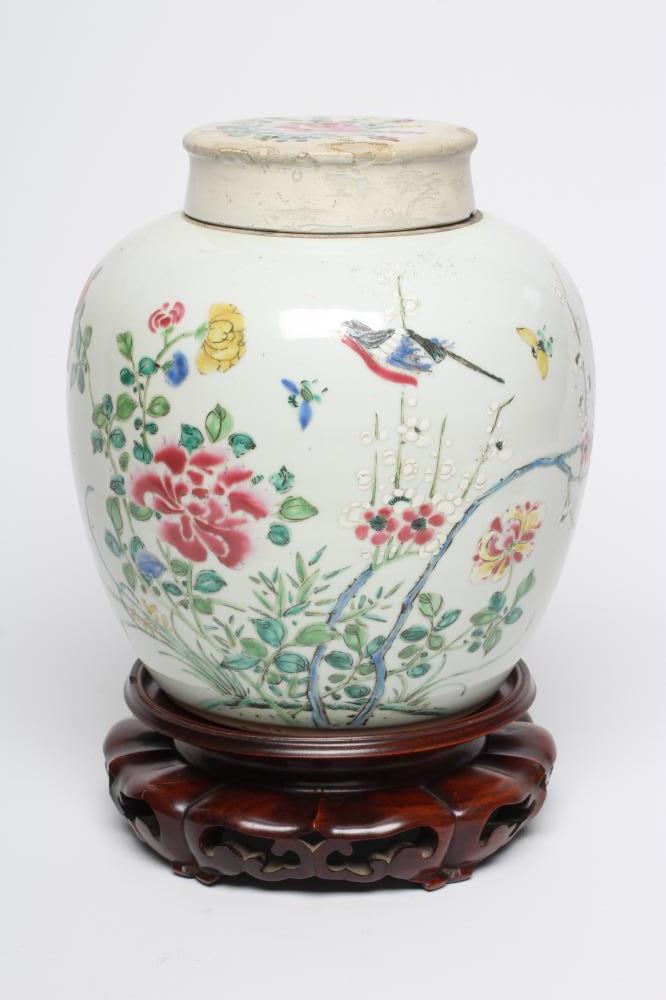 A CHINESE PORCELAIN LARGE JAR AND COVER painted in colours with a finch perched upon a blossoming Image