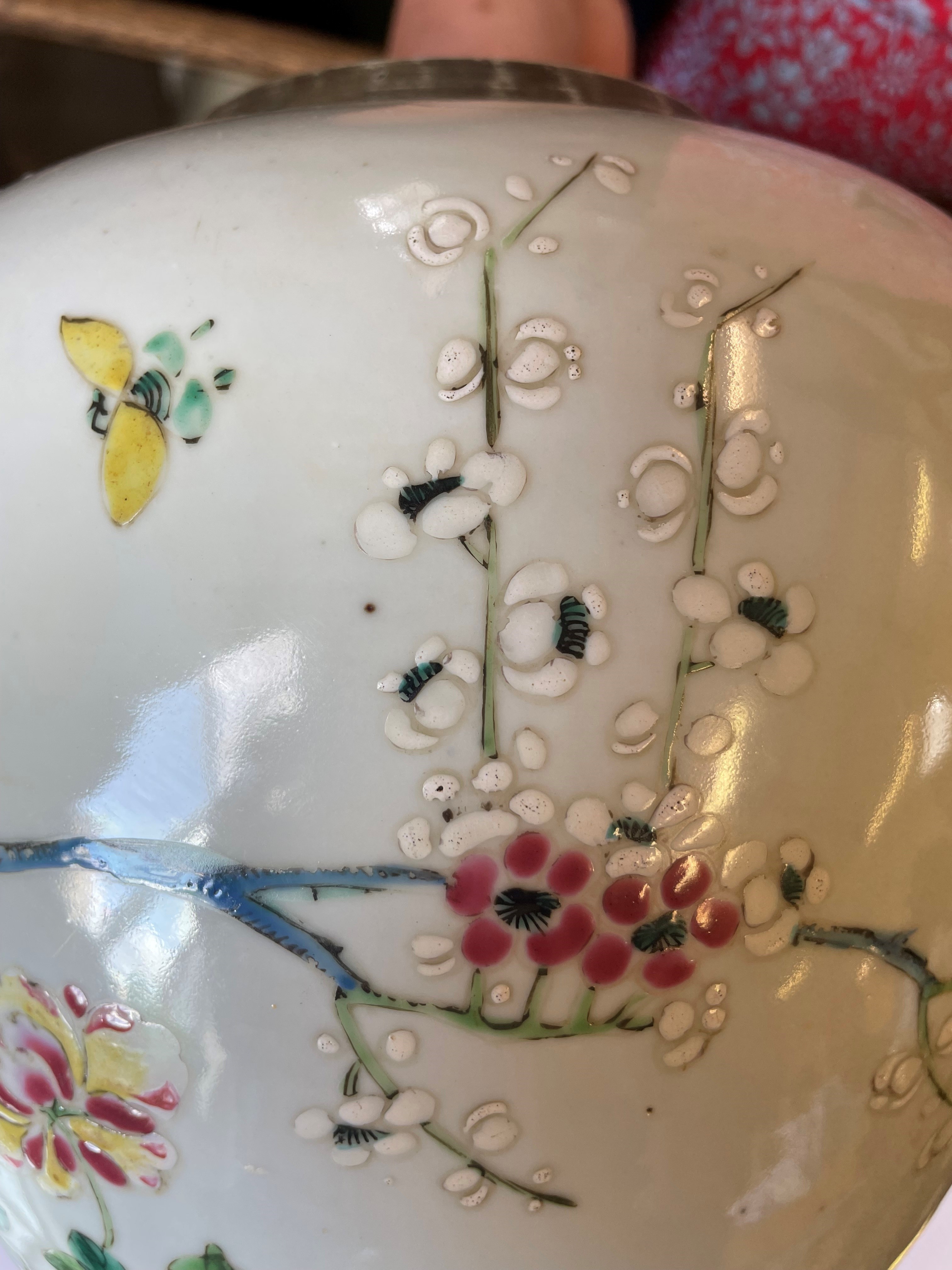 A CHINESE PORCELAIN LARGE JAR AND COVER painted in colours with a finch perched upon a blossoming Image