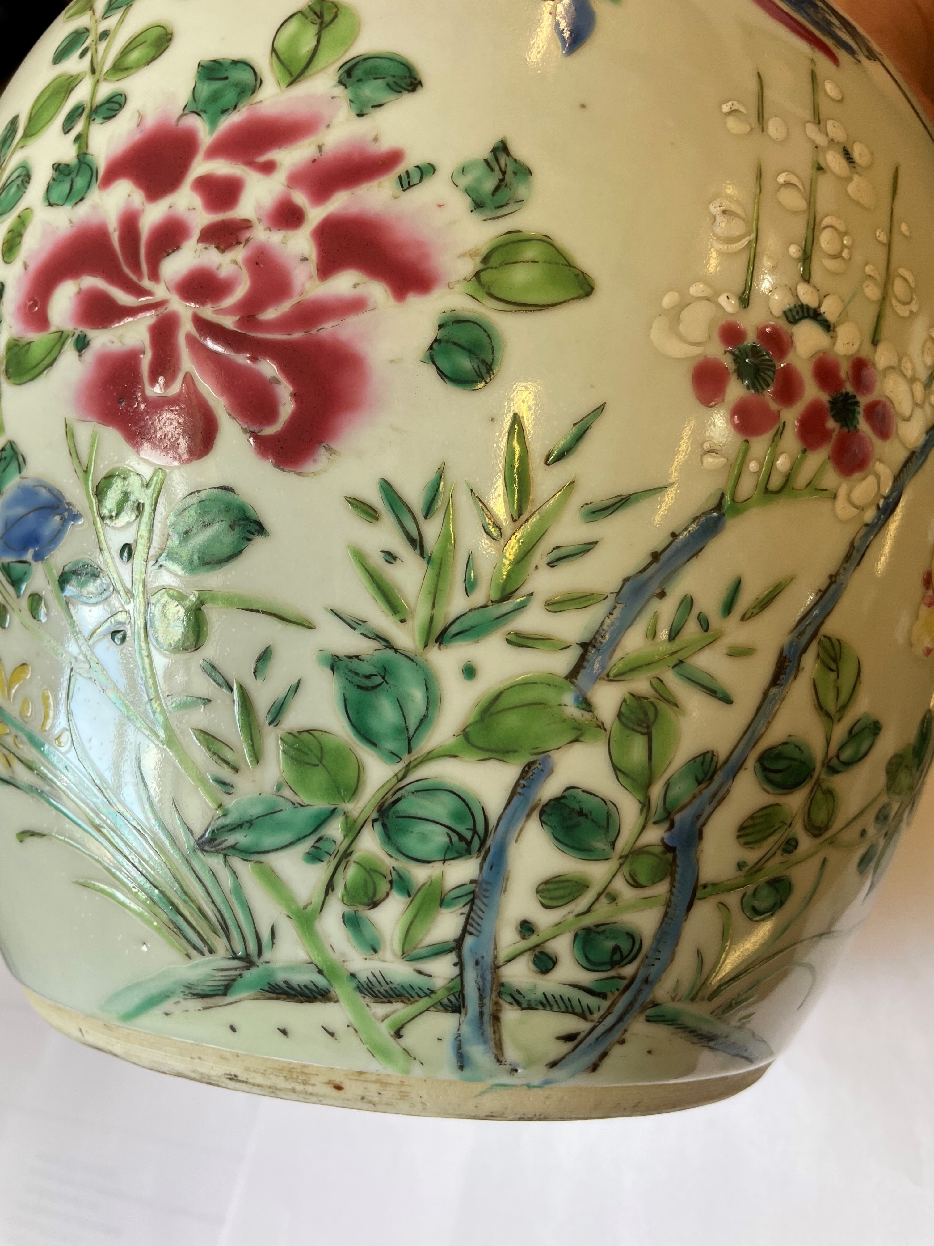 A CHINESE PORCELAIN LARGE JAR AND COVER painted in colours with a finch perched upon a blossoming Image