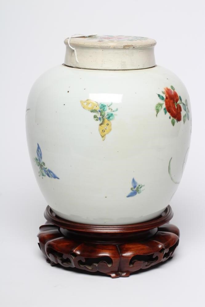 A CHINESE PORCELAIN LARGE JAR AND COVER painted in colours with a finch perched upon a blossoming Image