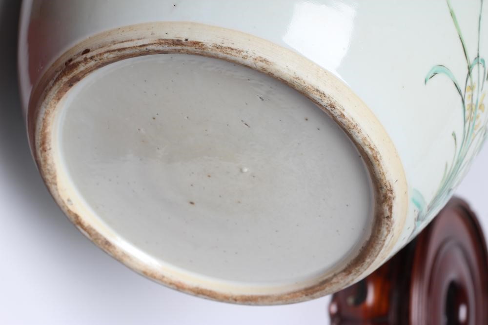 A CHINESE PORCELAIN LARGE JAR AND COVER painted in colours with a finch perched upon a blossoming Image