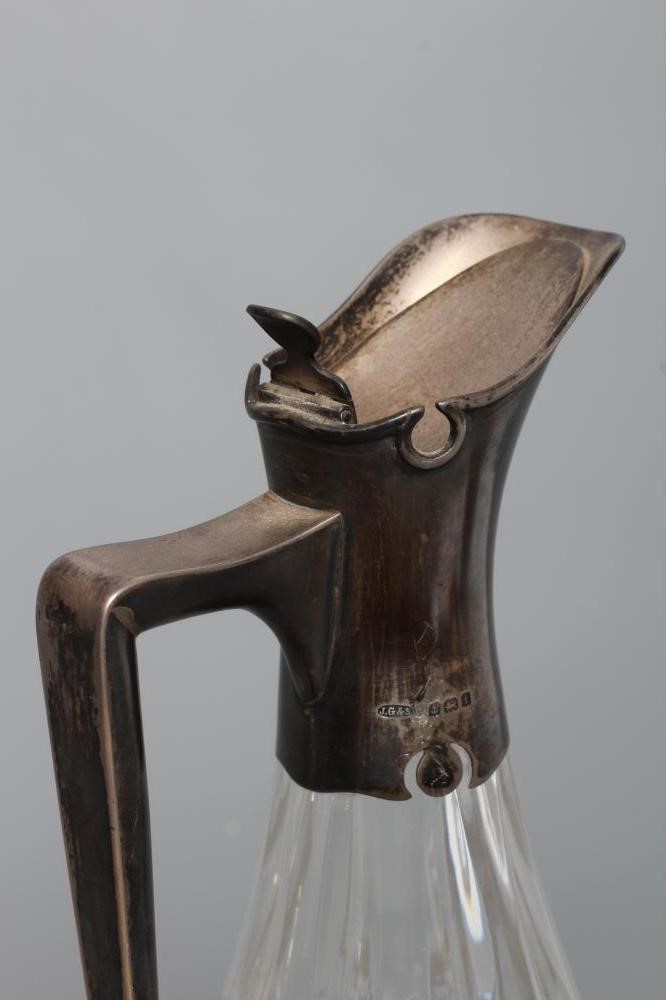 AN EDWARDIAN SILVER MOUNTED WINE JUG Image