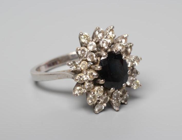 A SAPPHIRE AND DIAMOND CLUSTER RING Image