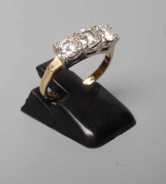 A THREE STONE DIAMOND RING, the round brilliant cut stones each of approximately 0.3cts, claw set to Image