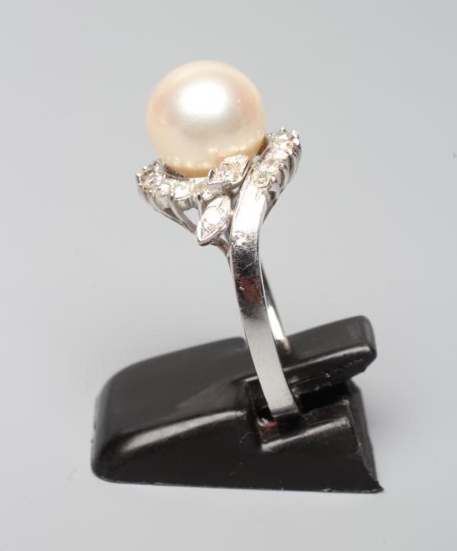A PEARL AND DIAMOND COCKTAIL RING, the cultured pearl set to a swirl border of small diamonds to a Image