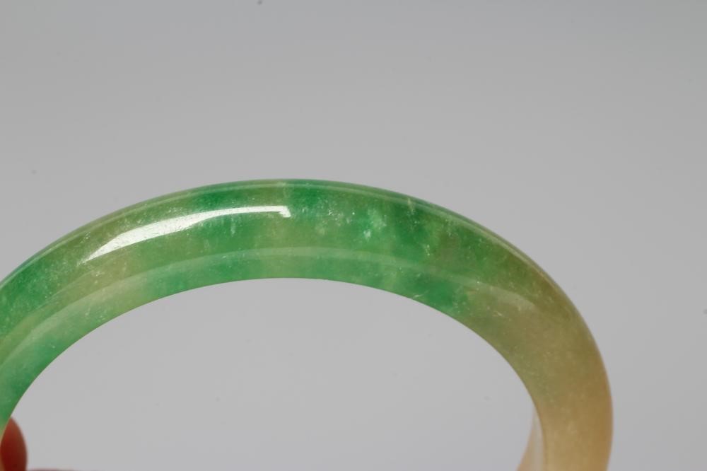 A POLISHED JADE BANGLE of D form, 37g, together with a silver mounted jade Shou pendant, stamped 925 Image