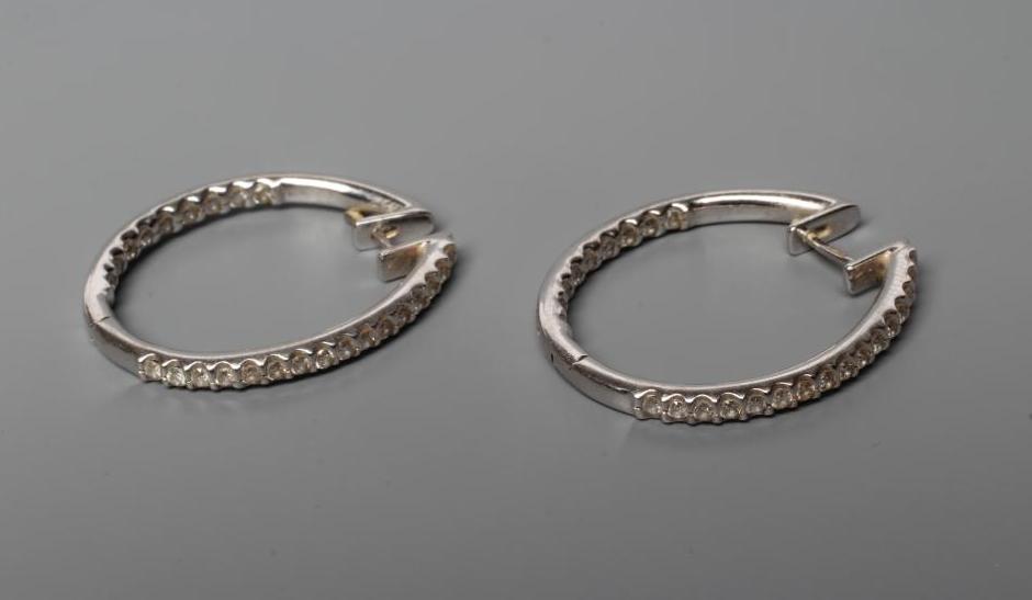 A PAIR OF DIAMOND HOOP EARRINGS, the half hinged rings point set with numerous small stones to the Image