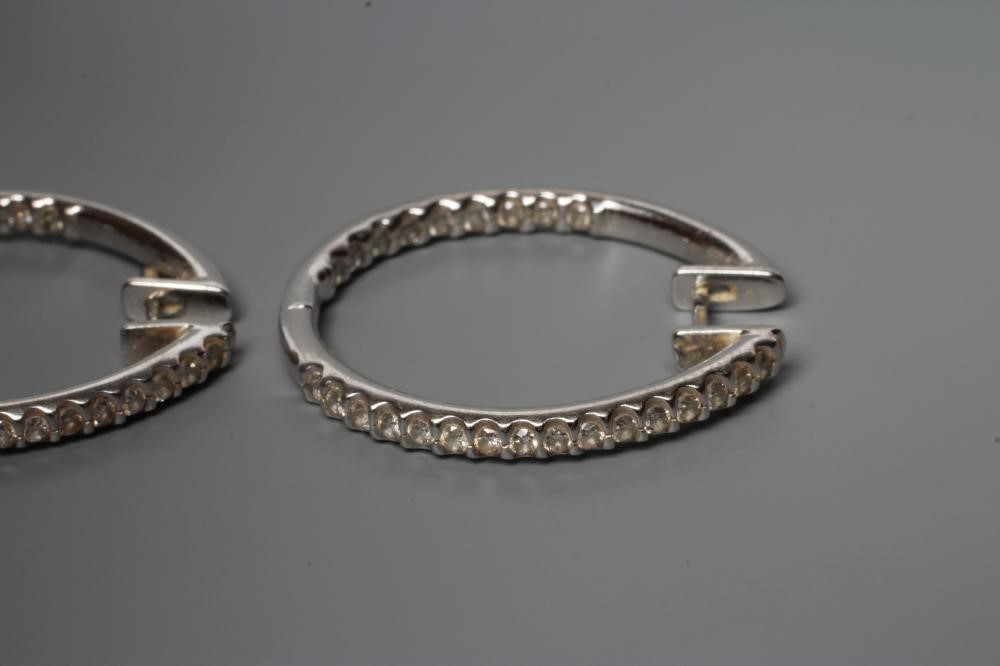 A PAIR OF DIAMOND HOOP EARRINGS, the half hinged rings point set with numerous small stones to the Image