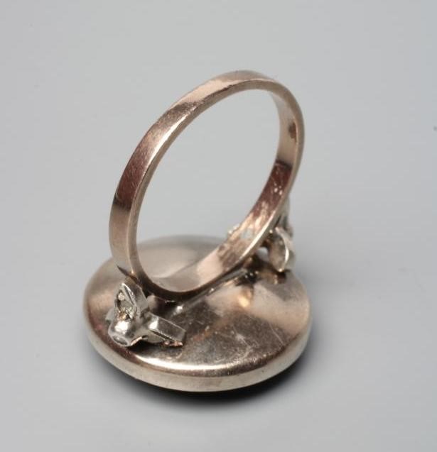 A DIAMOND TARGET RING, the circular panel point set with numerous mix cut (mostly rose cut) stones Image