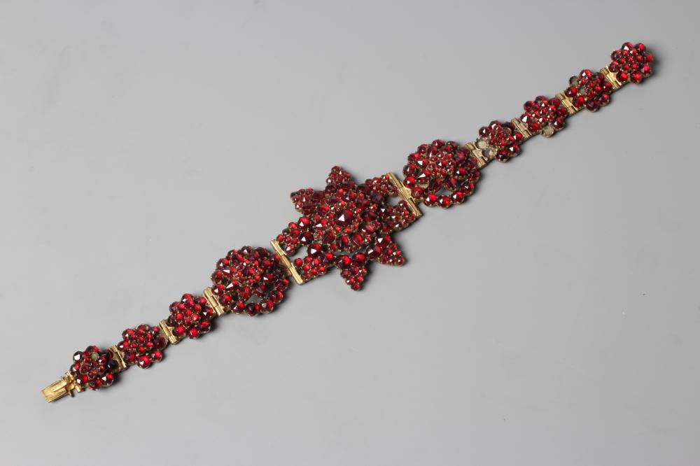 A LATE XIX CENTURY BOHEMIAN GARNET BRACELET, the central star panel hinged to smaller clusters on a Image