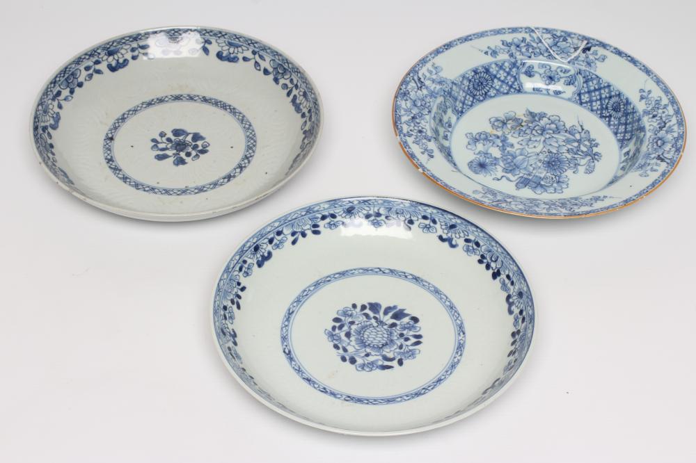 TWO CHINESE PORCELAIN SAUCER DISHES painted in underglaze blue with a flower spray within a diapered Image
