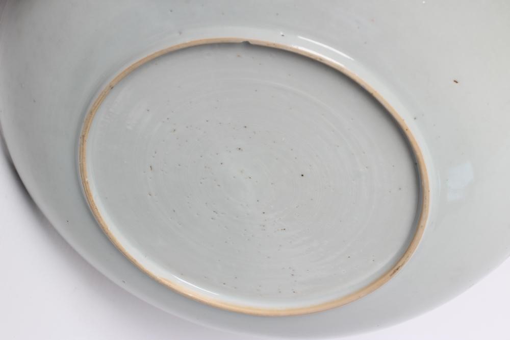 TWO CHINESE PORCELAIN SAUCER DISHES painted in underglaze blue with a flower spray within a diapered Image